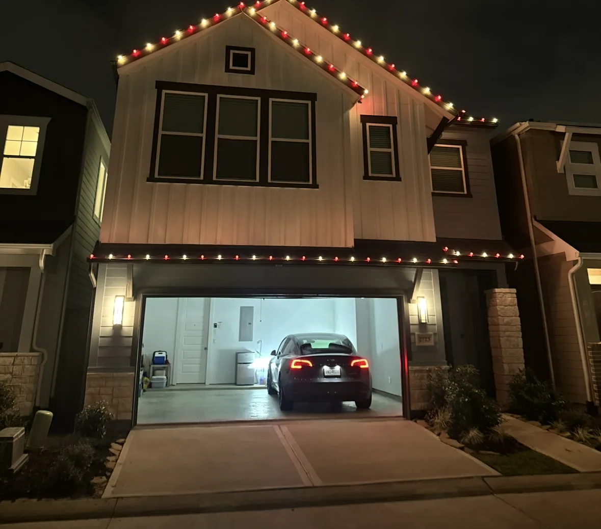 Wedding and event lighting in Houston: modern farmhouse gables outlined in alternating red and warm white bulbs